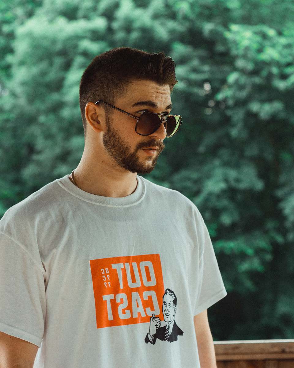 person man wearing white and orange crew-neck t-shirt clothing