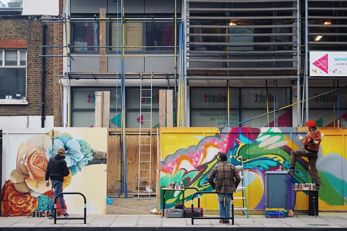 person men painting graffiti on wall human