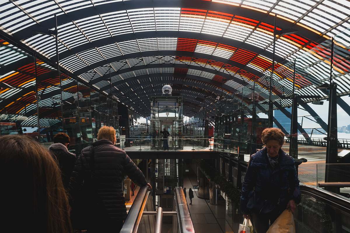 human people riding escalator inside building person