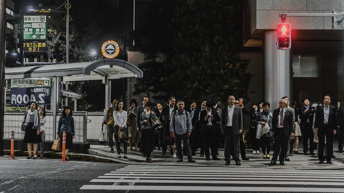 road people standing in front of pedestrian lane during daytime tokyo