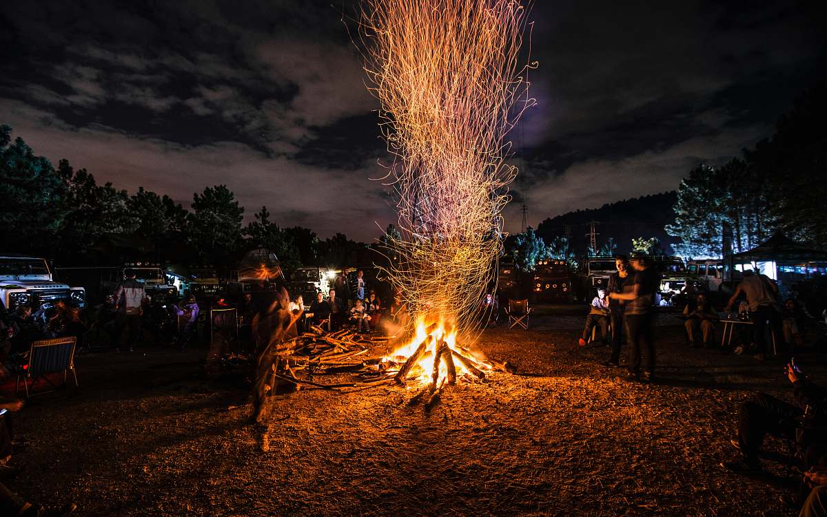 human people standing next to bonfire person