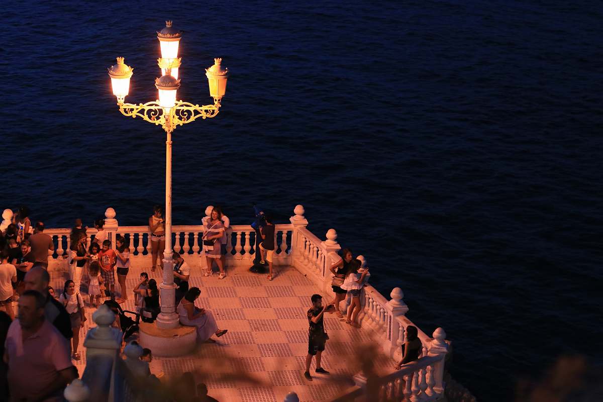 person people standing on balcony during night human