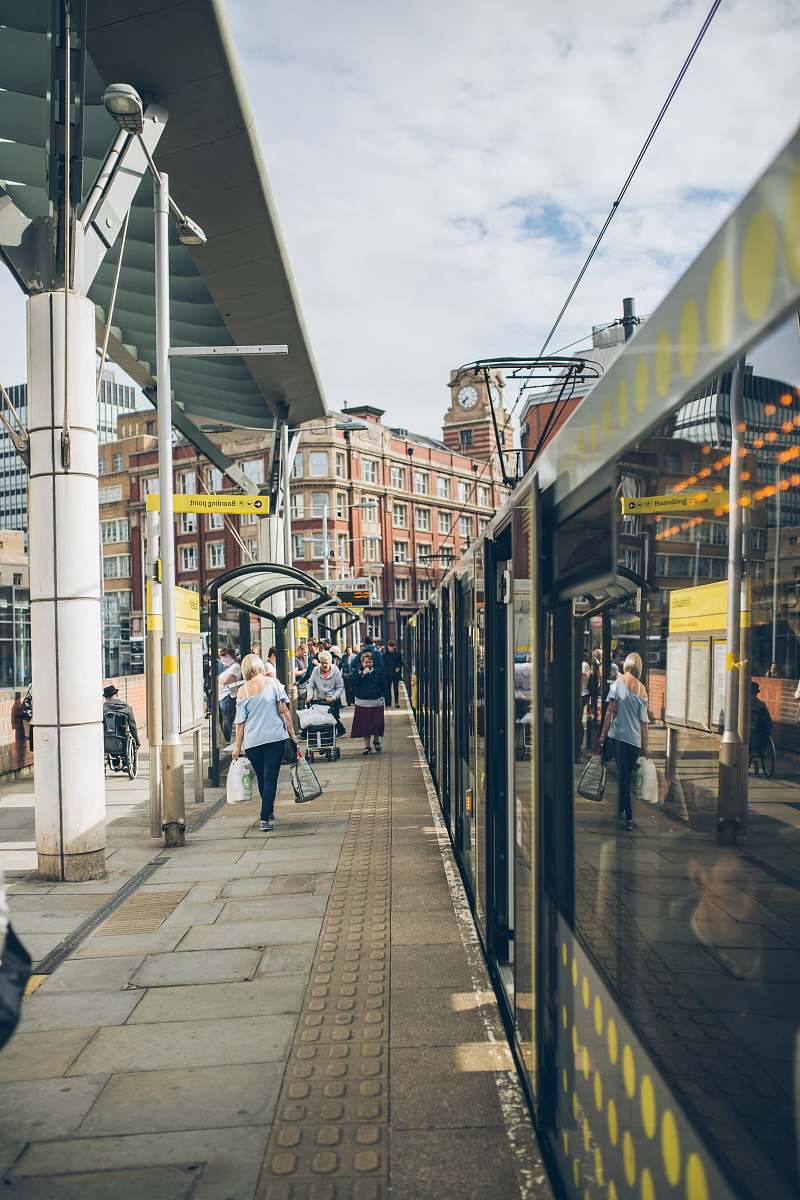 pavement people waling on train station sidewalk