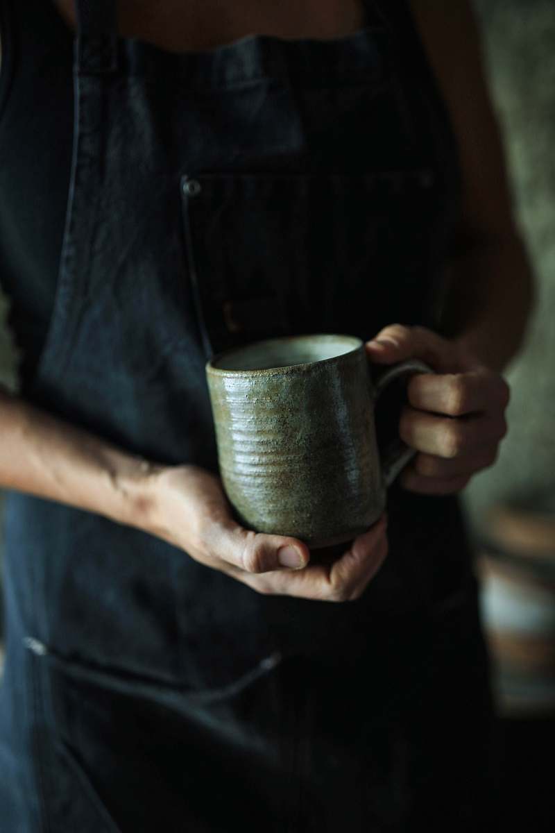 human person holding ceramic mug person