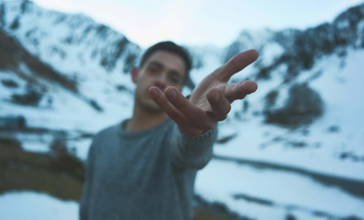 person person on snow covered mountain during daytime human