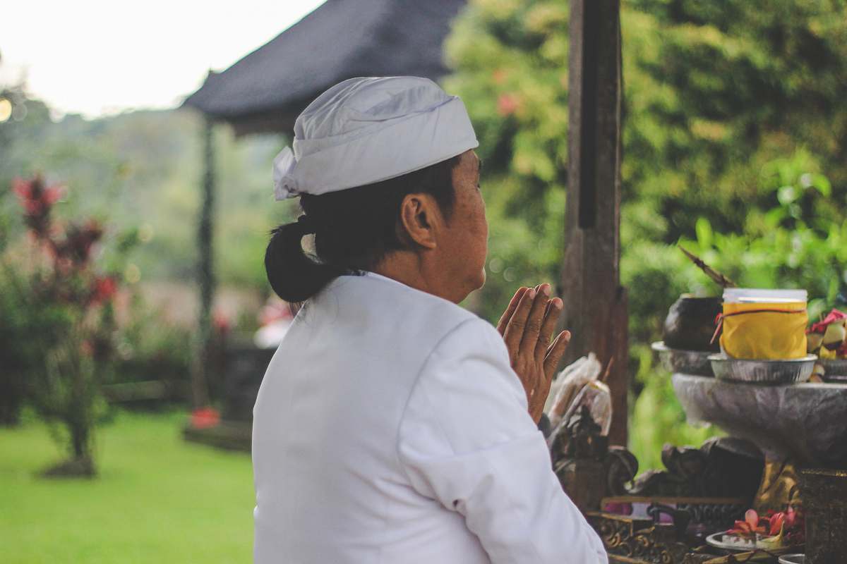 human person praying in front of table person