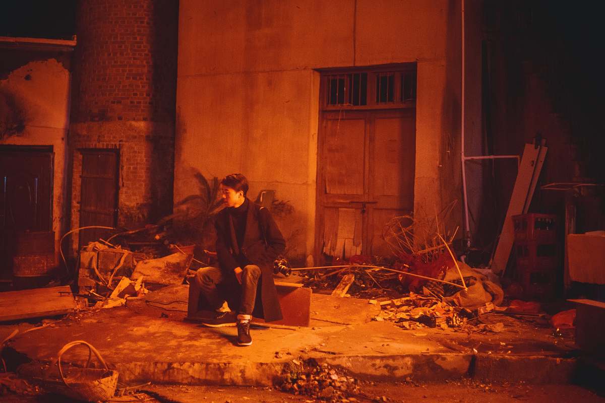 human person sitting on chair in middle of houses person