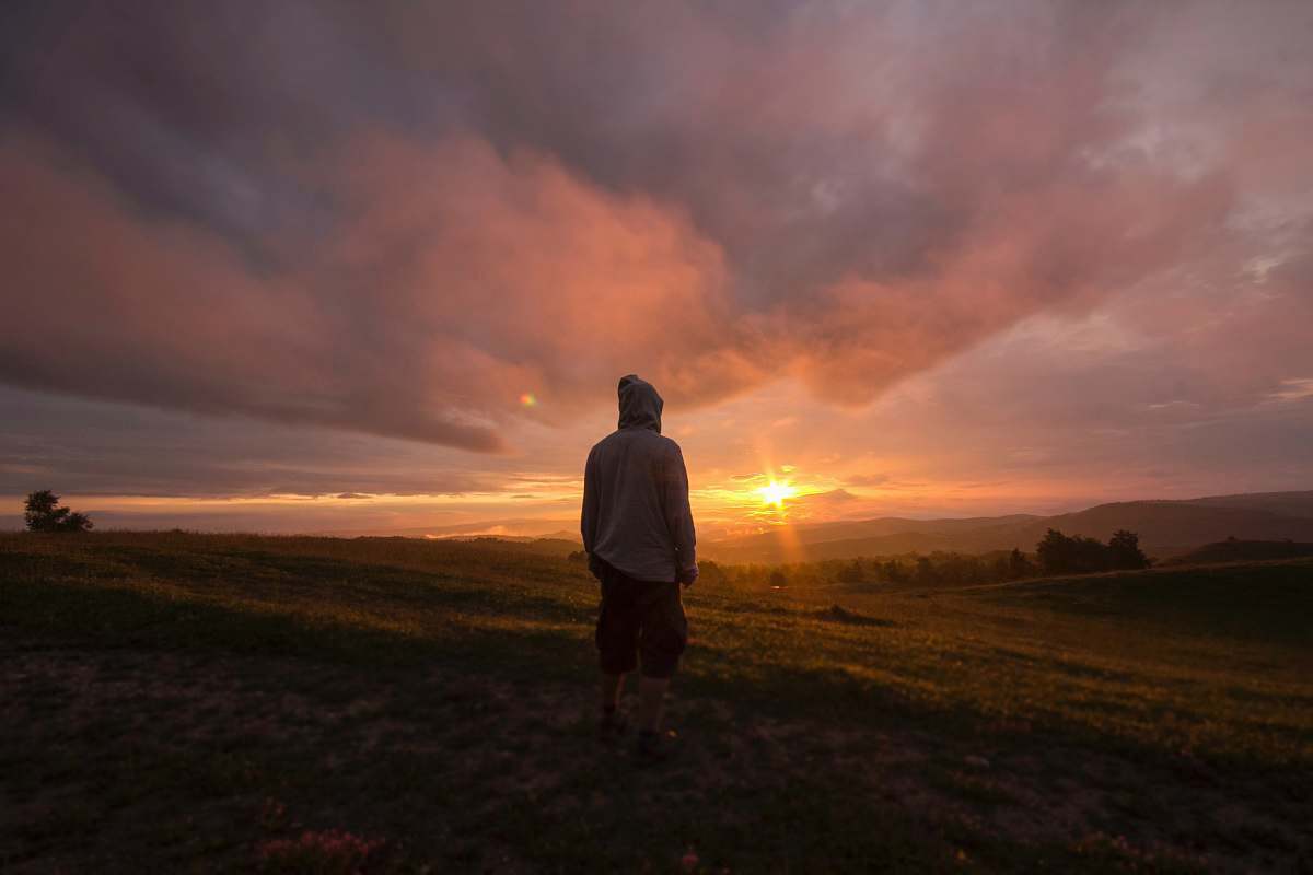 person person standing in front of sunset human