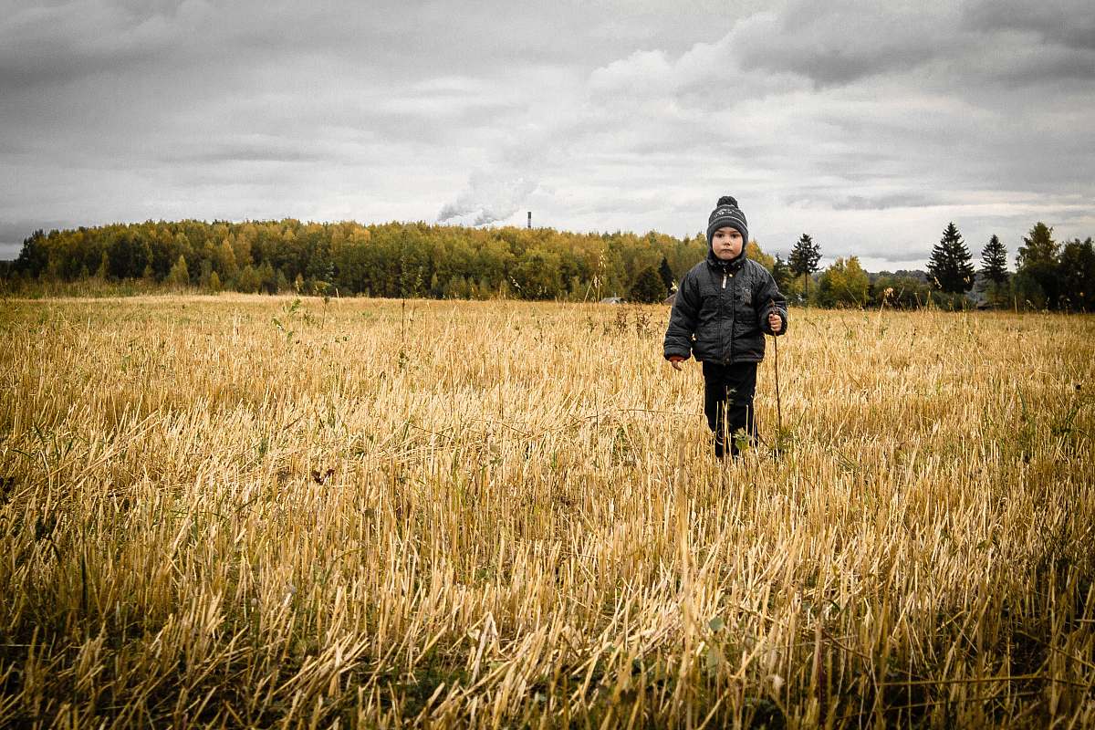 person person standing on rice field under white sky at daytime human