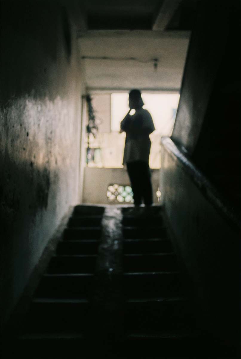 human person standing on stairs inside the building person