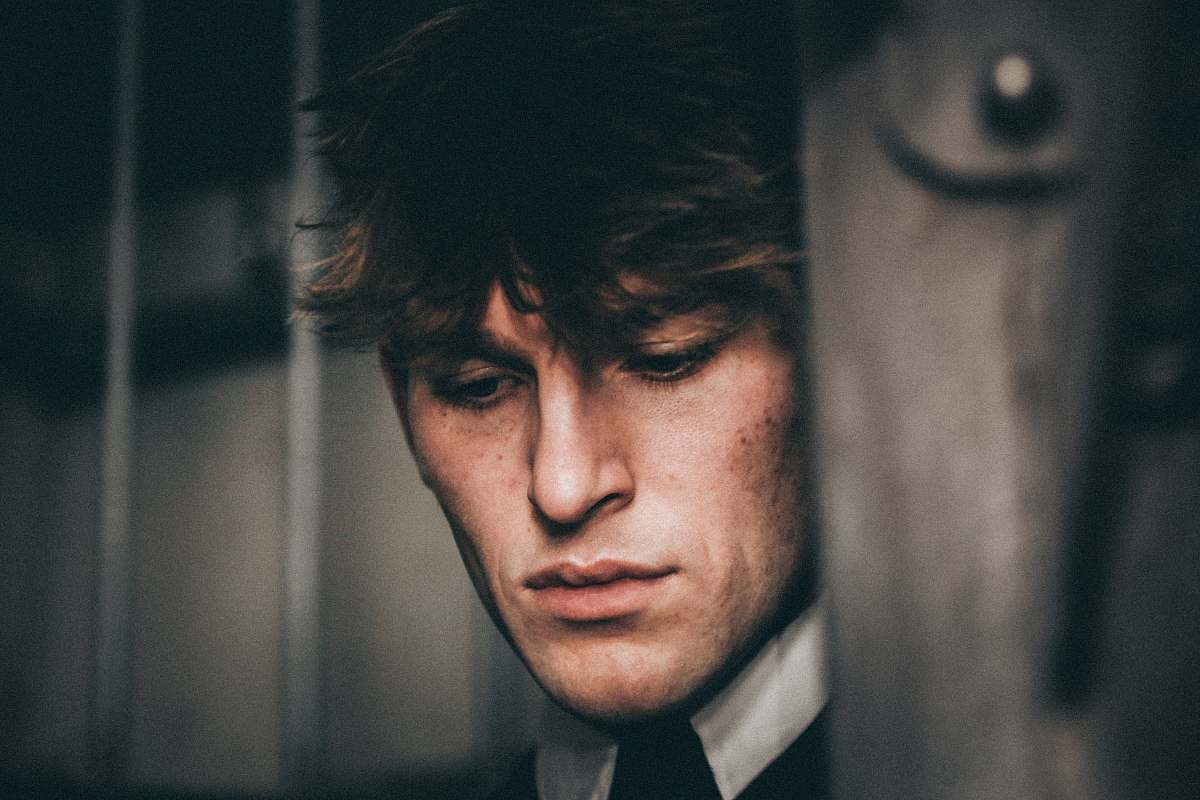 person photo of man face near brown wooden board human