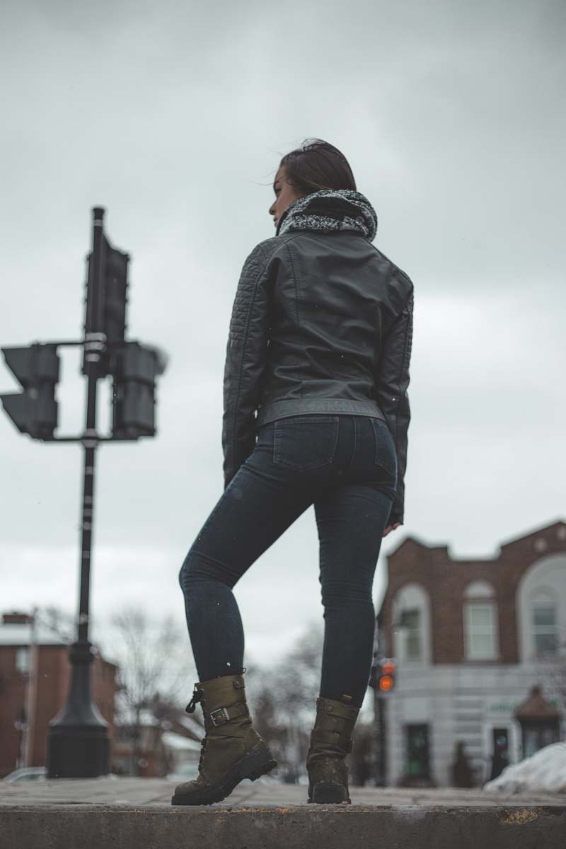 human selective focus photo of woman standing on roadway grey