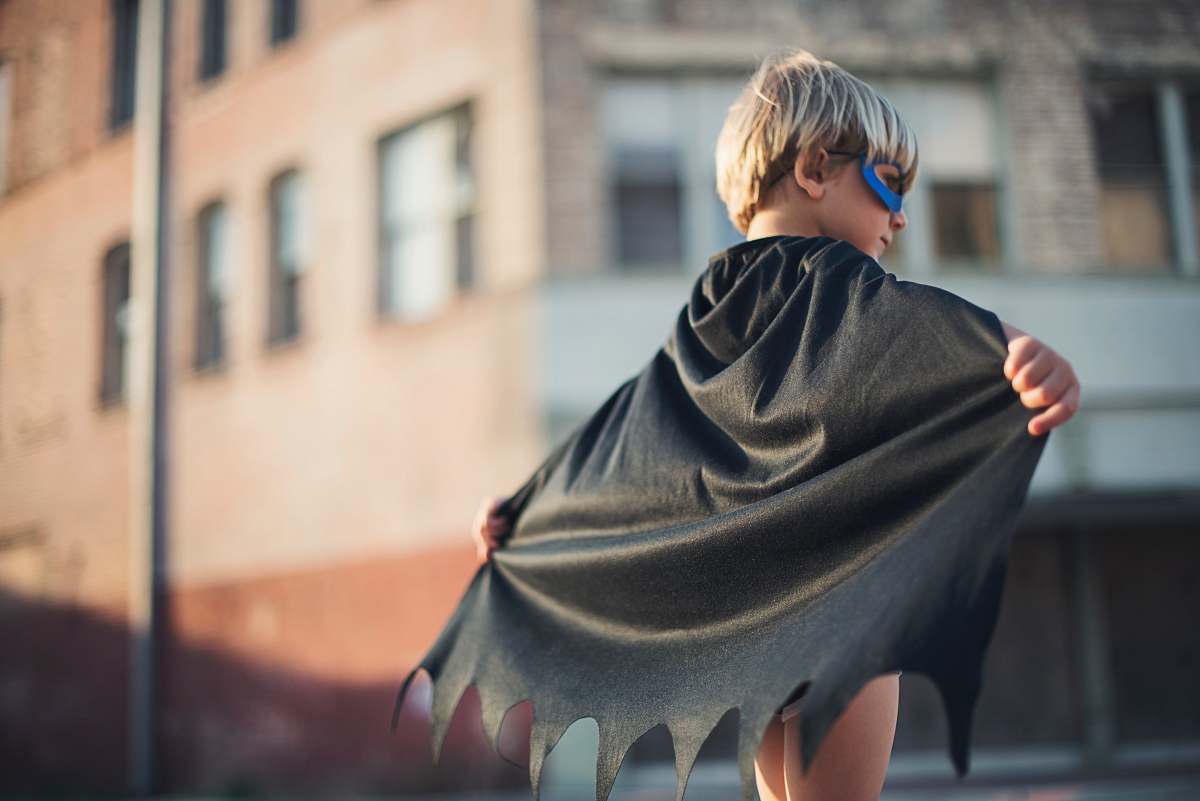 human selective focus photography of boy wearing black Batman cape person
