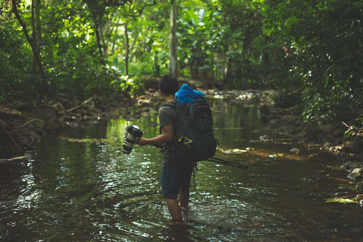 human shallow focus photography of man walking in river person