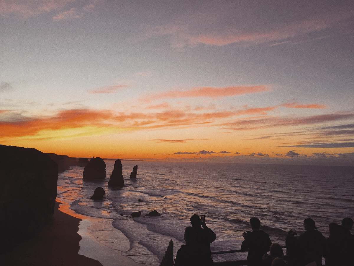 person silhouette of people standing near 12 Apostles landmark in Australia human