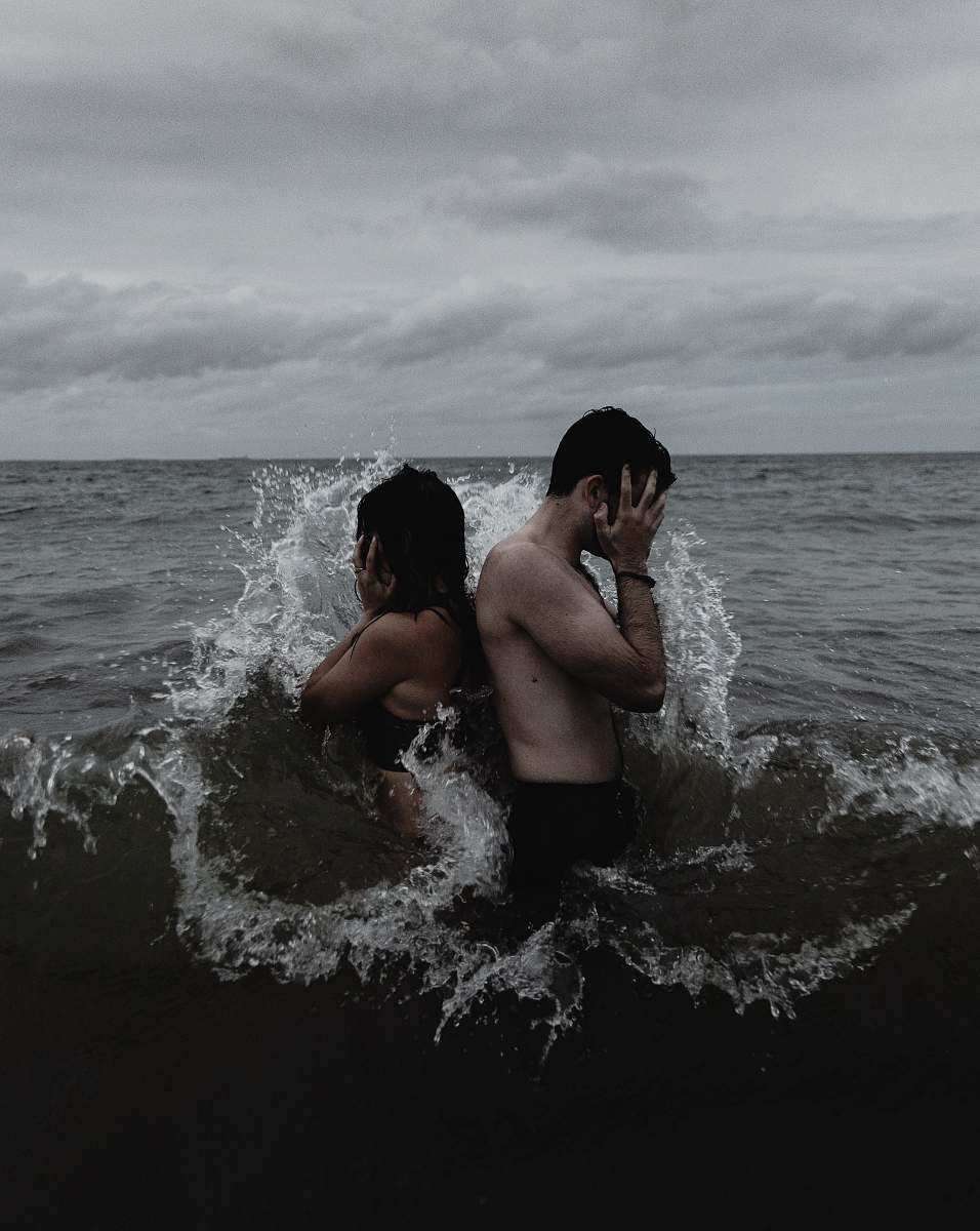 human time lapse photography of couple standing on body of water person