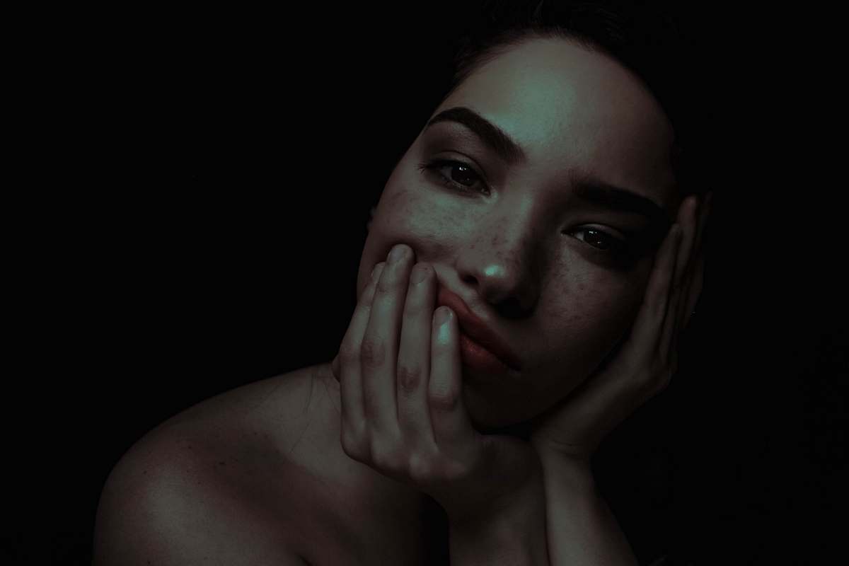 human topless woman with head resting on palm person