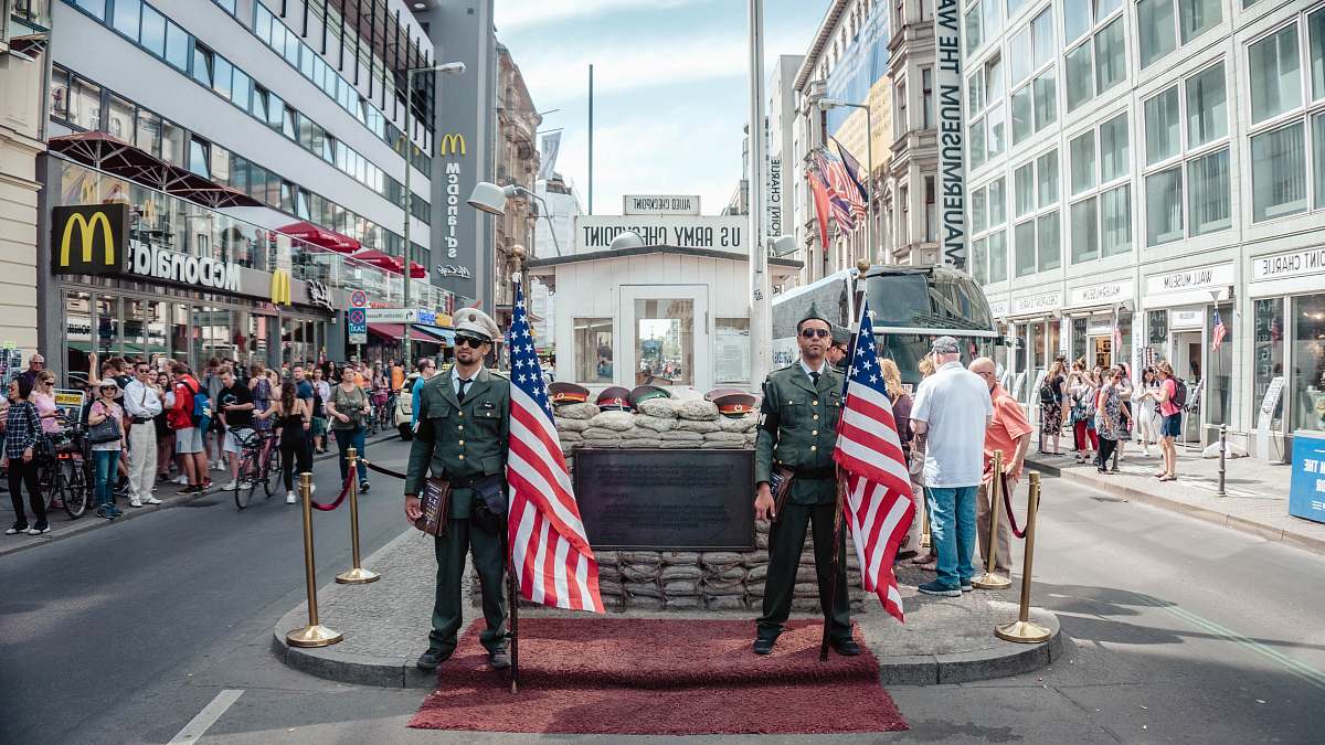 human two men holding USA flags outdoors person