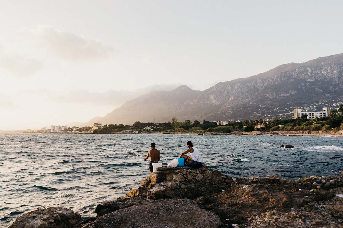 human two men near sea at daytime person