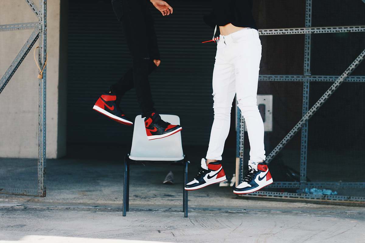 human two people wearing Air Jordan shoes jumping person