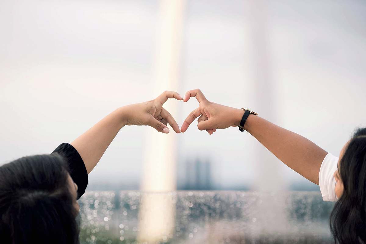 person two person doing heart hand sign during daytime human