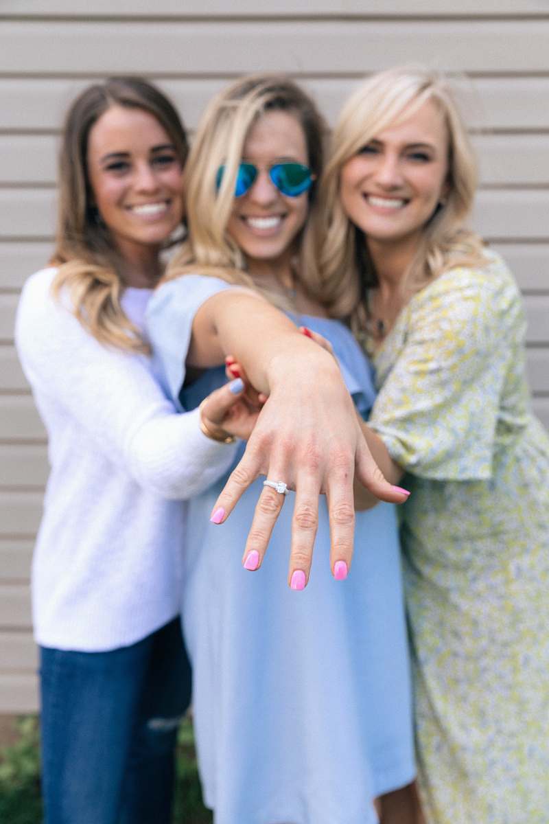 person two women holding woman's hand in the middle woman