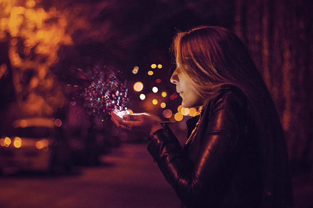 human woman blowing sprinkle in her hand person