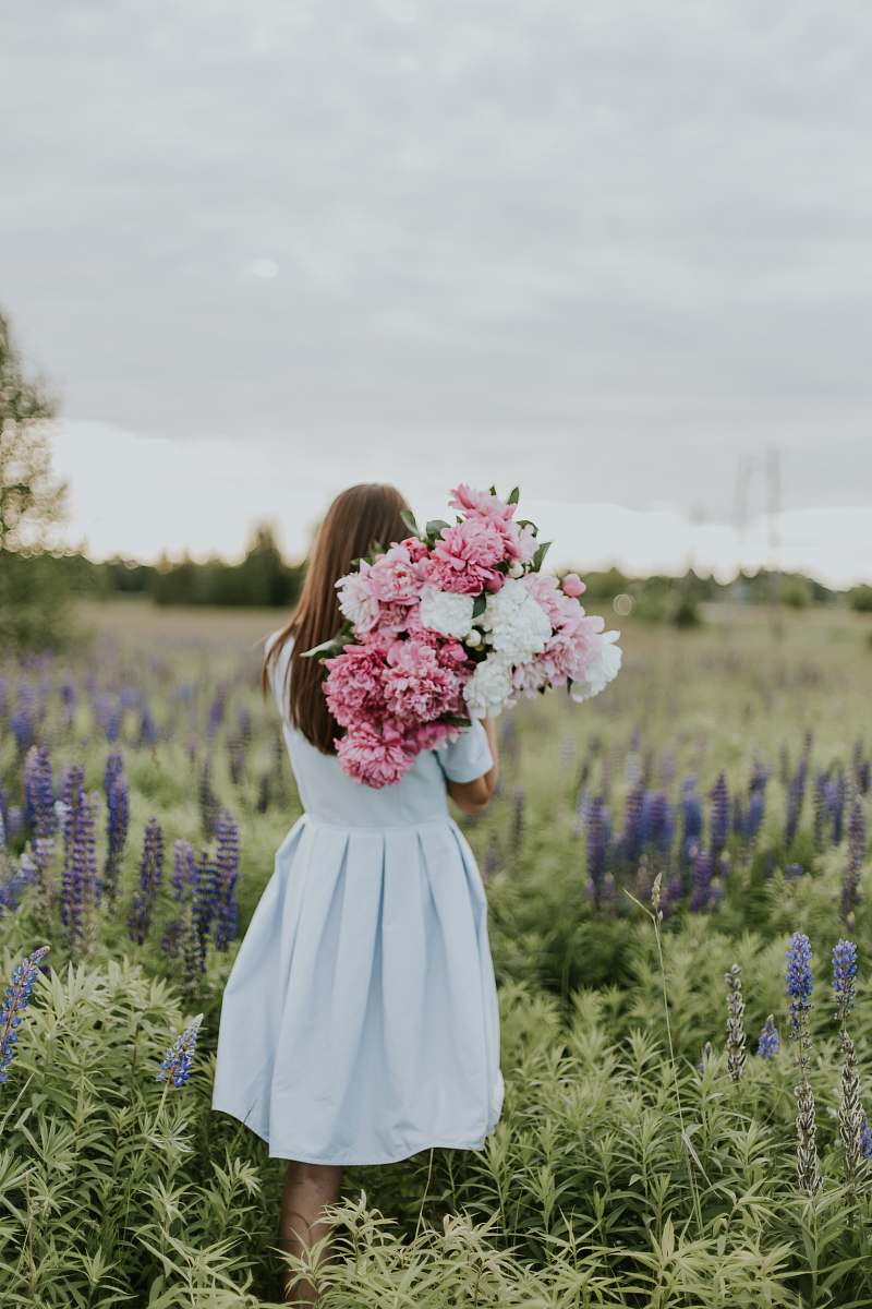 human woman carrying pink and white flowers person