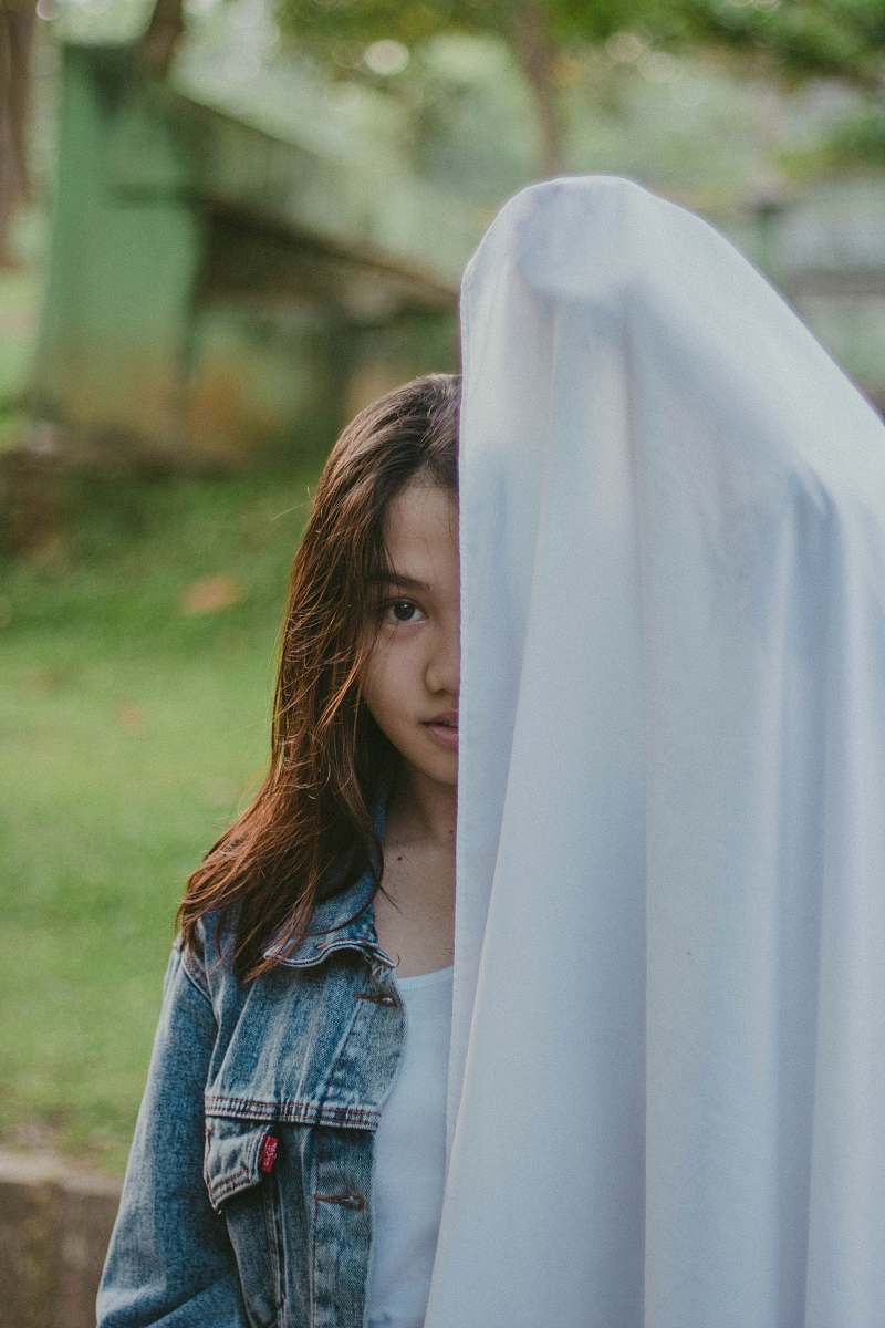 human woman covered half of her face with cloth person