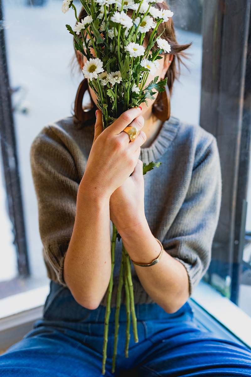 person woman covering her face with white flowers human