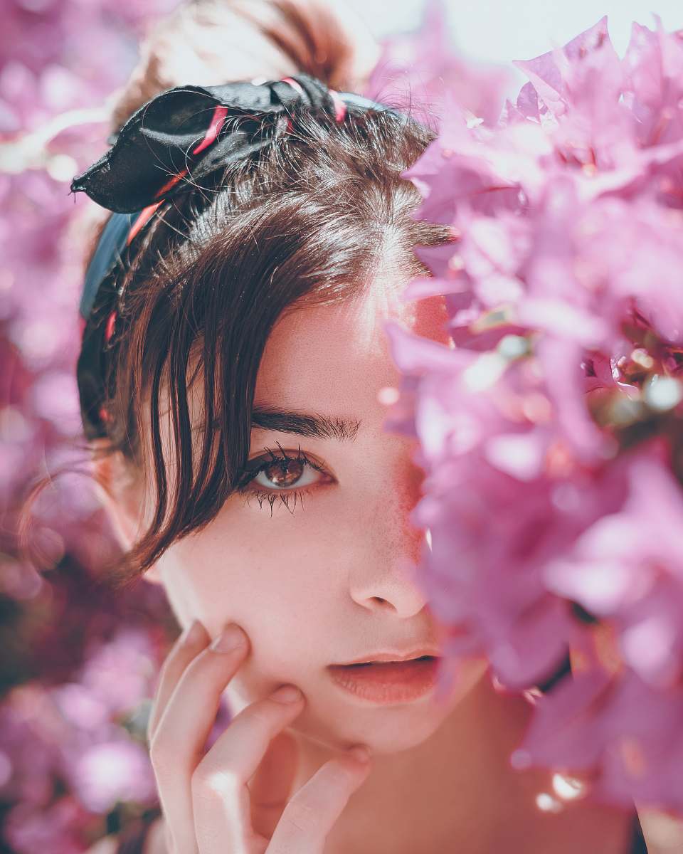 human woman hiding on pink petaled flowers person