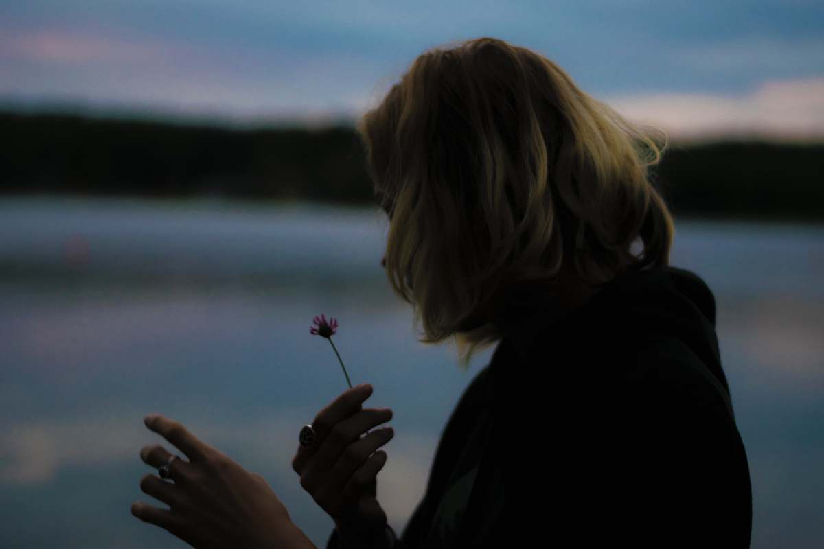 human woman holding flower hand