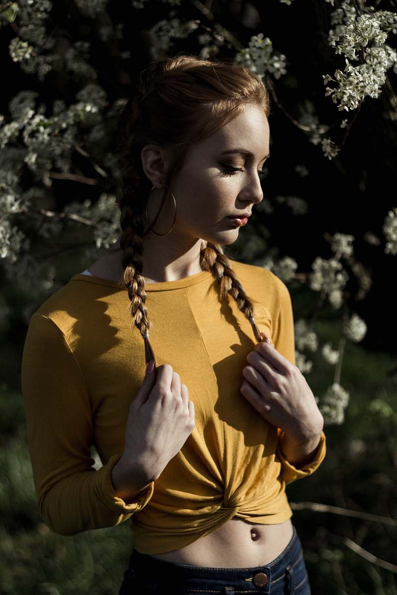 human woman holding her hair standing in front of tree person