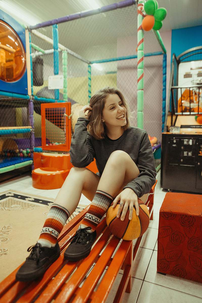 human woman holding her hair while sitting on bench person