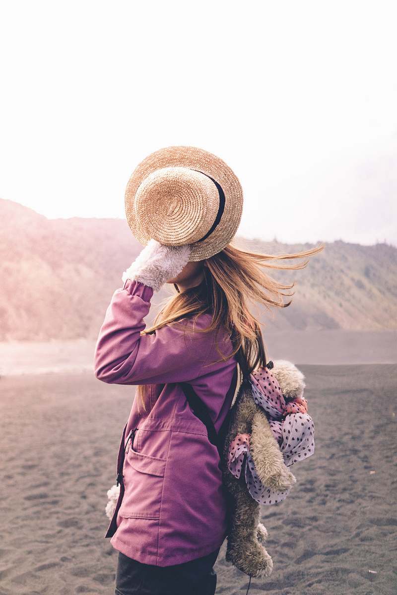 human woman holding his brown hat person