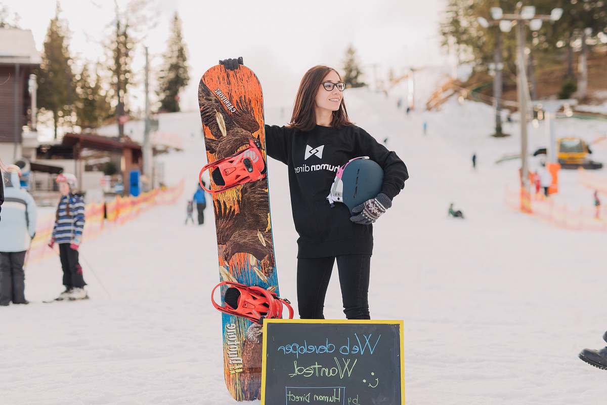 human woman holding orange and brown surfboard person