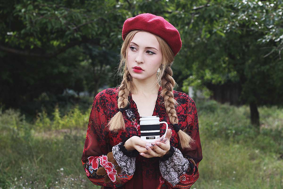 human woman holding white and black mug person