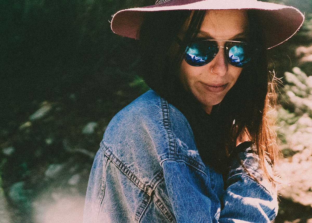human woman in denim jacket wearing shades person