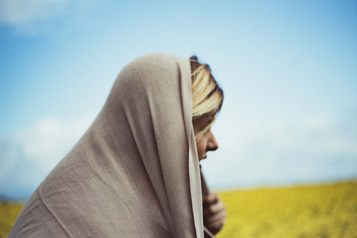 person woman in gray headdress on grass field in fashion photography human
