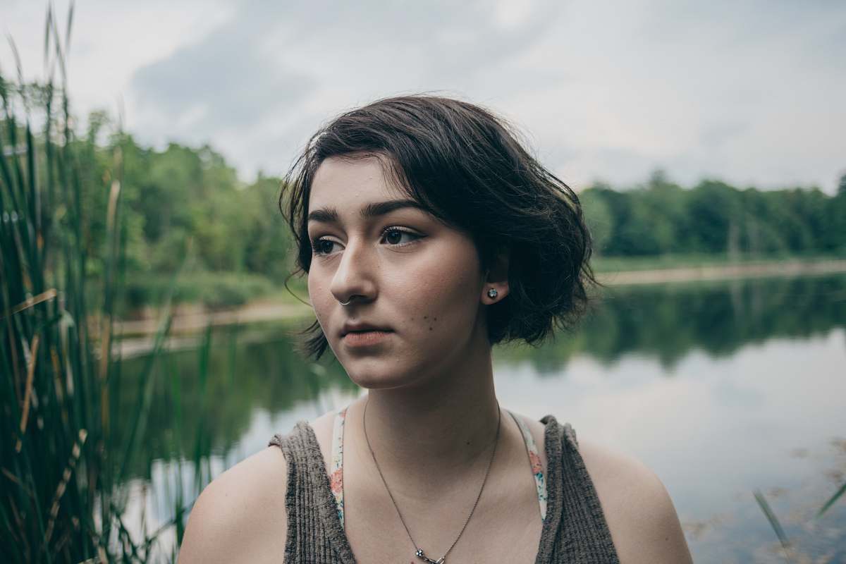 person woman in gray tank top with body of water background human