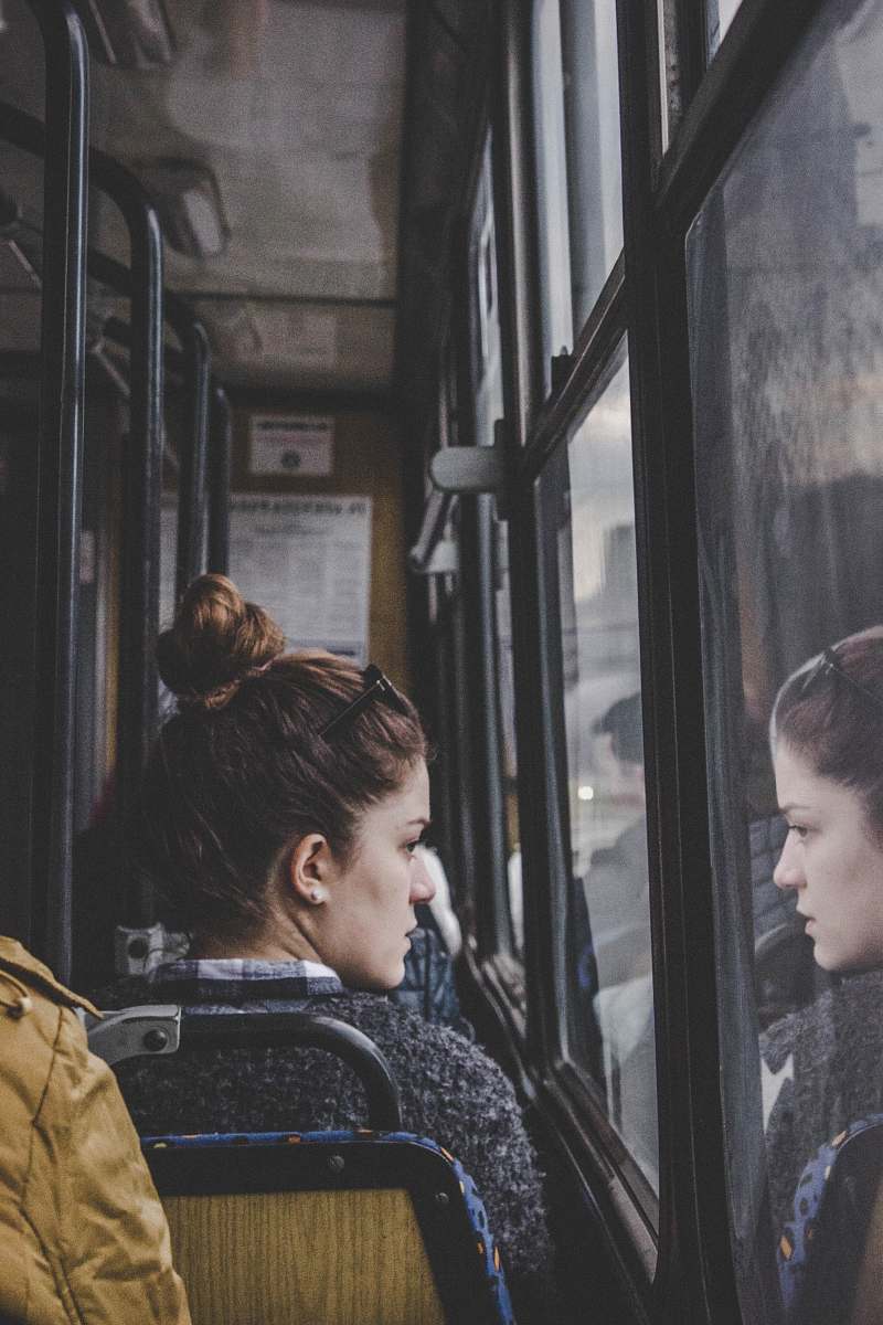 person woman in gray top sitting on passenger seat human