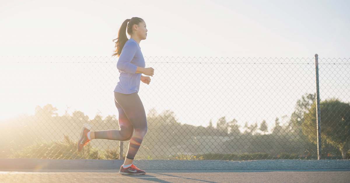 person woman jogging near wire fence human