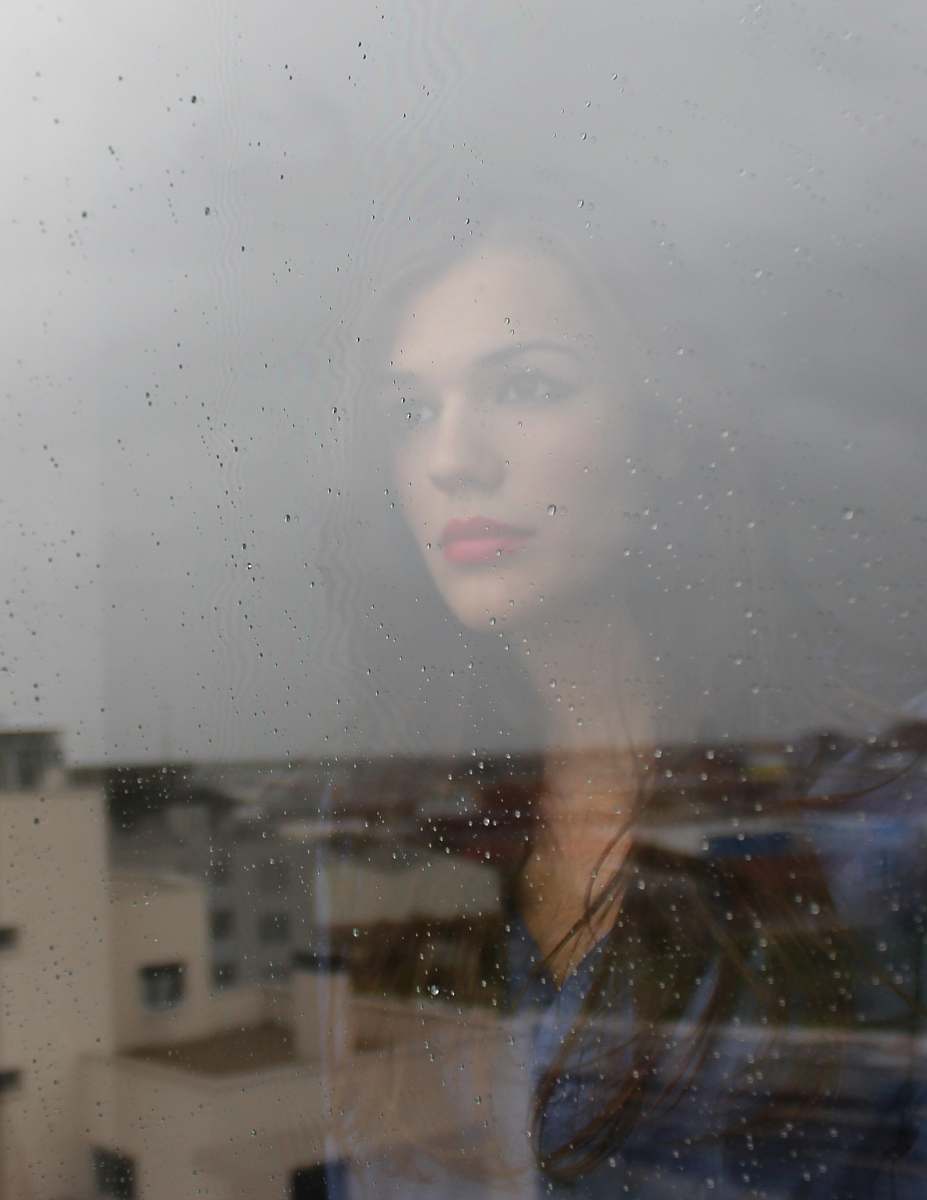 woman woman looking through window window