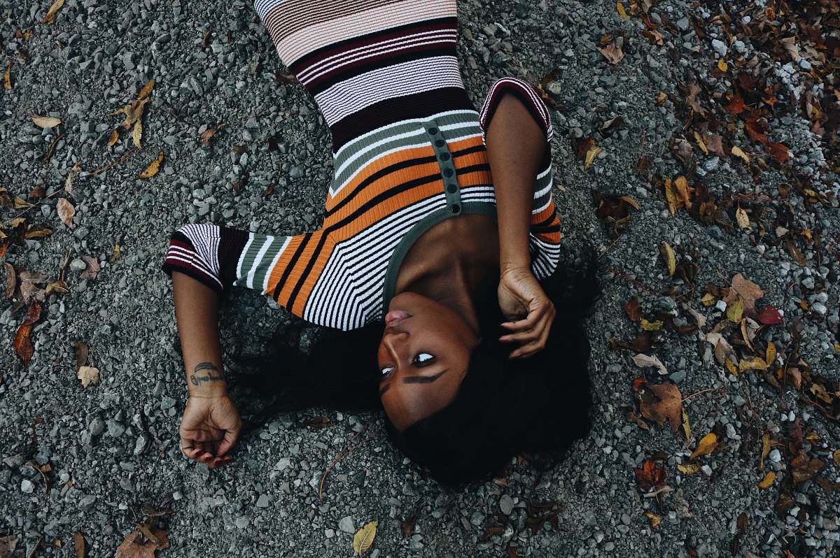 person woman lying on sand hair