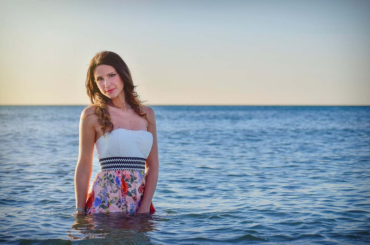 person woman on ocean wearing dress talking photo during sunset human