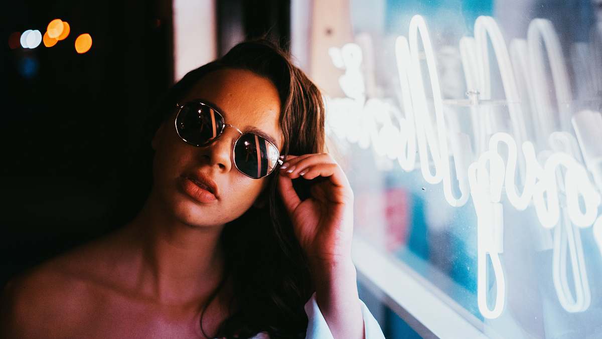 human woman sitting beside the glass window glasses