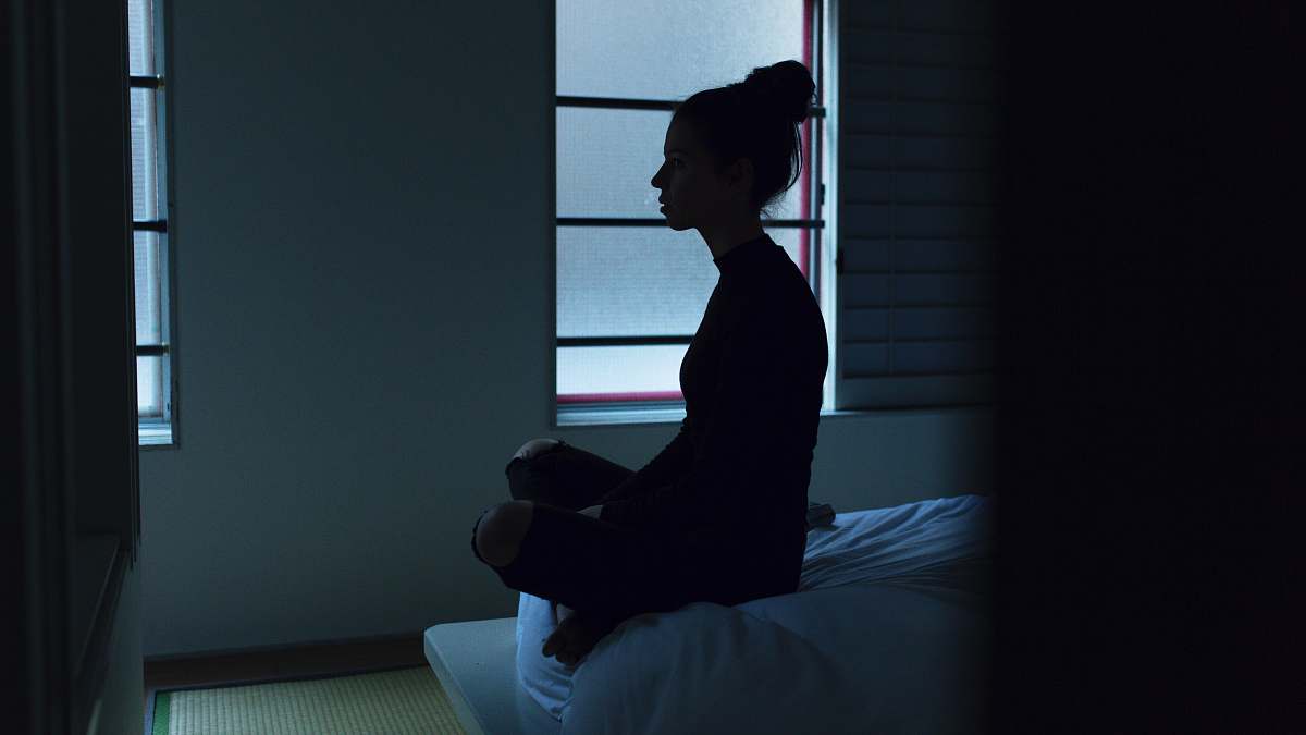 person woman sitting on bed human