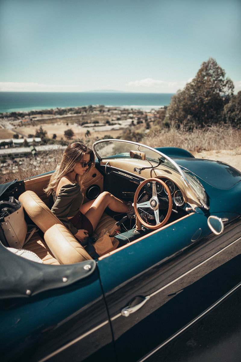 automobile woman sitting on car car