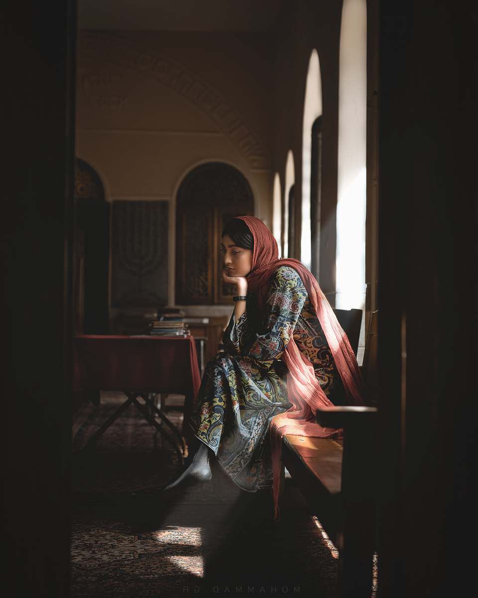 human woman sitting on chair while looking down person