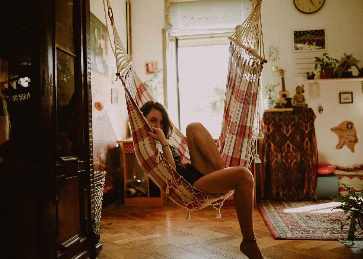 human woman sitting on hammock person